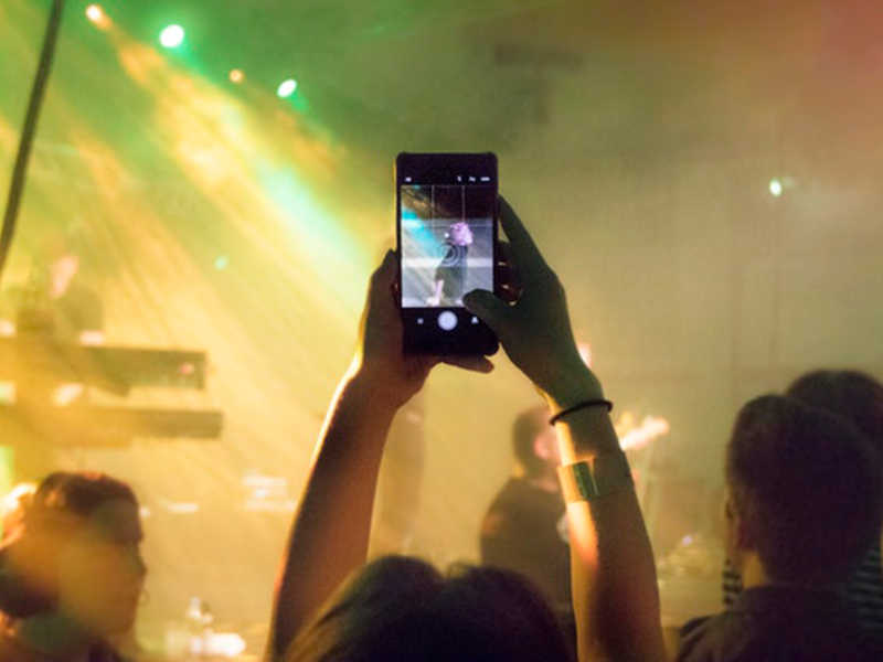 phone camera taking picture of nightclub stage