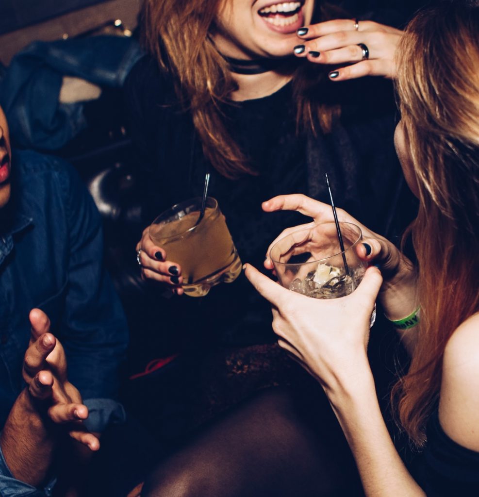 Two women drinking alcohol and laughing