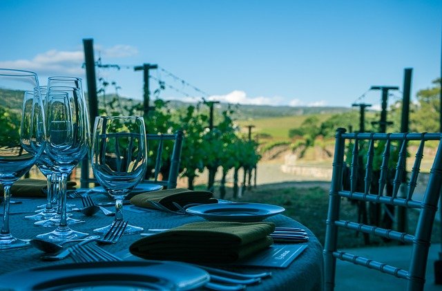 Wine glass on an outdoor table overlooking Napa Valley