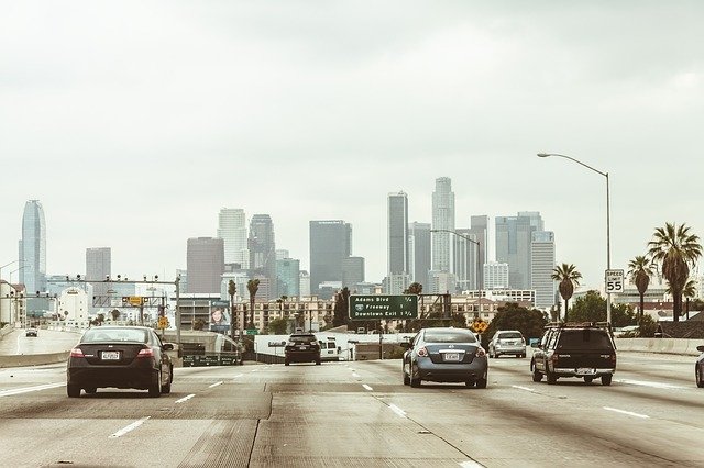 los angeles highway with cars driving towards the city center