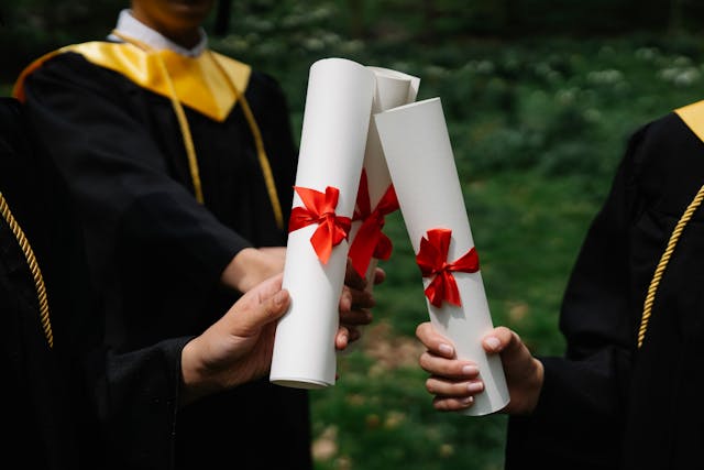 graduates holding degrees
