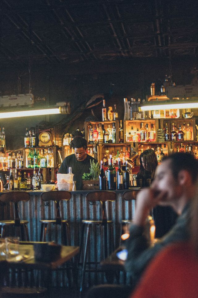 bar interior,m bartender mixing drinks